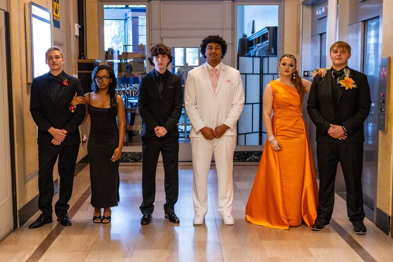Group portrait of six people dressed for a formal event